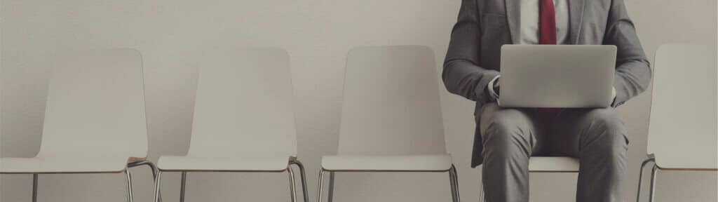 Join KissMyMac as a Mac repair specialist - candidate waiting with a laptop before an interview