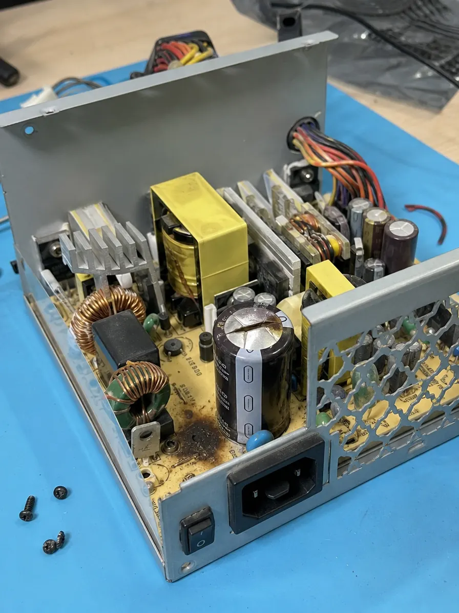 Blown capacitor on a Mac Pro power supply unit, the cause of a pop sound and burnt smell after a power surge